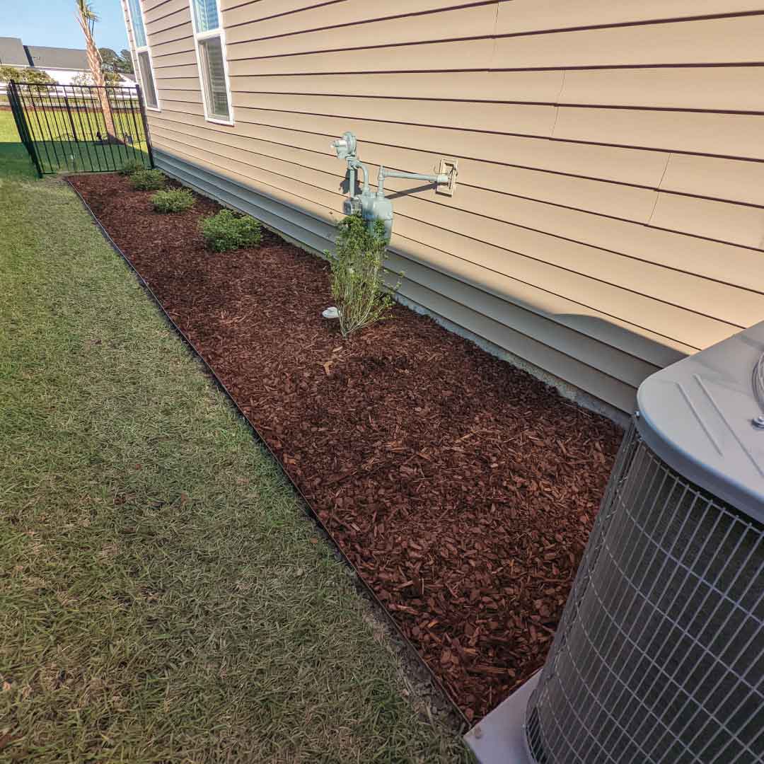 Foundation mulch bed with aluminum edging in Little River