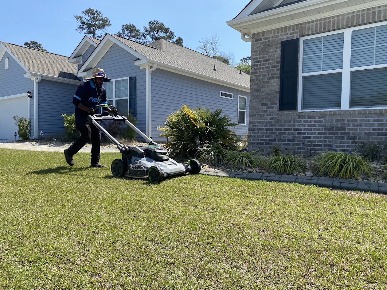 Justin mowing a lawn for Neon Pest and Lawn