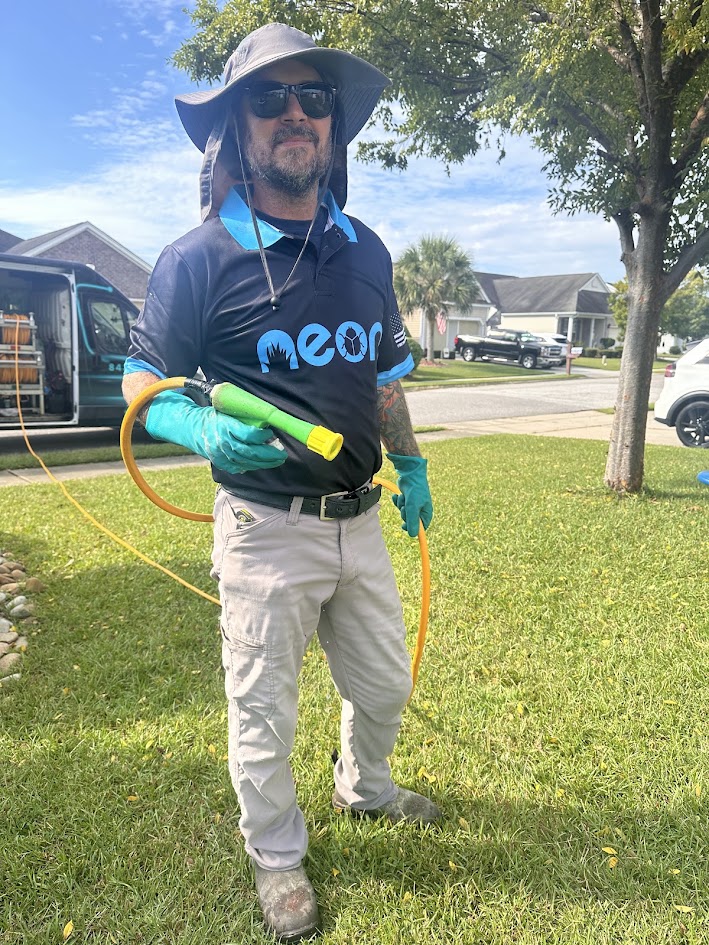 Neon technician applying a lawn treatment on a Murrells Inlet property