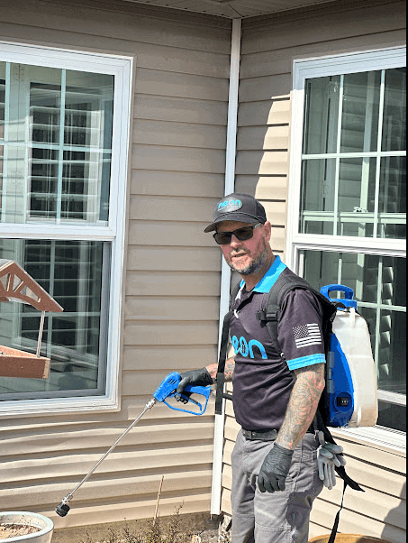 Neon Pest and Lawn's employee wearing a pest control backpack to provide pest control solution