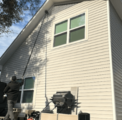 A Neon Pest and Lawn employee exterminates pests outside a client's house, ensuring a pest-free environment.