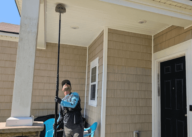 employee cleans a porch