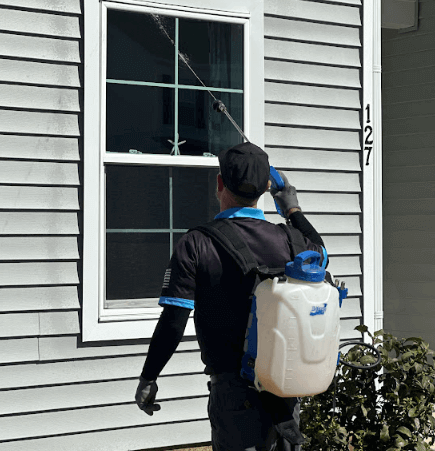 uses a sprayer to apply cricket control treatment